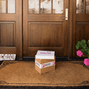 Two boxes with packaging tape at door step
