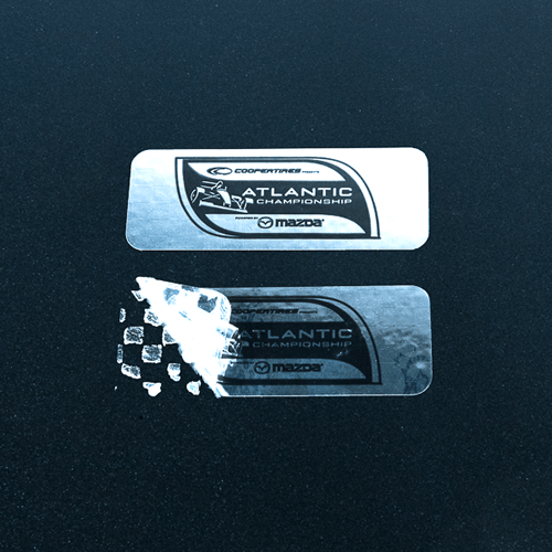 Silver rectangular label with logo and checkerboard residue pattern