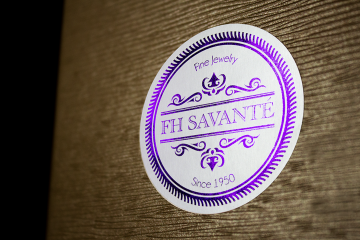 Exquisite fine jewelry collection featuring purple foil-stamped labels.