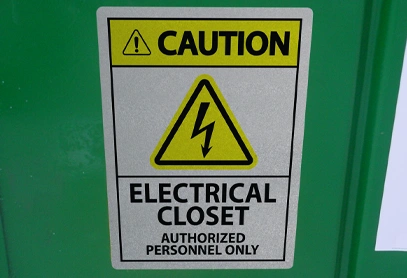 Industrial Safety Caution Electrical Closet Label Caution sign reading "Electrical Closet – Authorized Personnel Only" with a high-voltage symbol, mounted on a green surface for safety compliance.