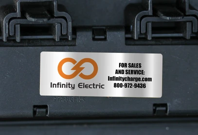 Durable Vinyl – Convex 6 mil Safety Industrial Label for Equipment Vinyl Convex 6 mil Industrial Label displaying the Infinity Electric logo and contact information, affixed to a black industrial surface.