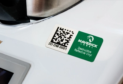 Outdoor Vinyl Destructible Reflective White Outdoor Vinyl Destructible Reflective White asset label on equipment showing a 2D barcode and serial number.