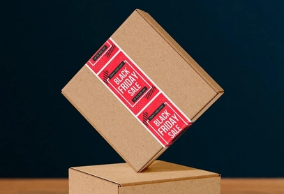 A brown shipping box sealed with custom Black Friday Sale packaging tape, perfect for retail labels, promotional branding, and e-commerce packaging.