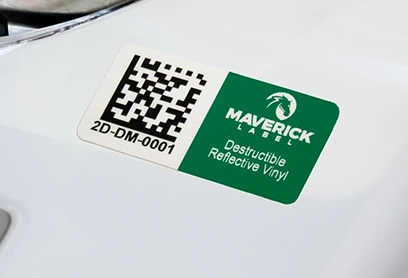 Tamper-Proof Labels for Secure Asset Tracking A tamper-proof label made from destructible reflective vinyl by Maverick Label, featuring a QR code and serial number for secure asset tracking and anti-tampering protection.